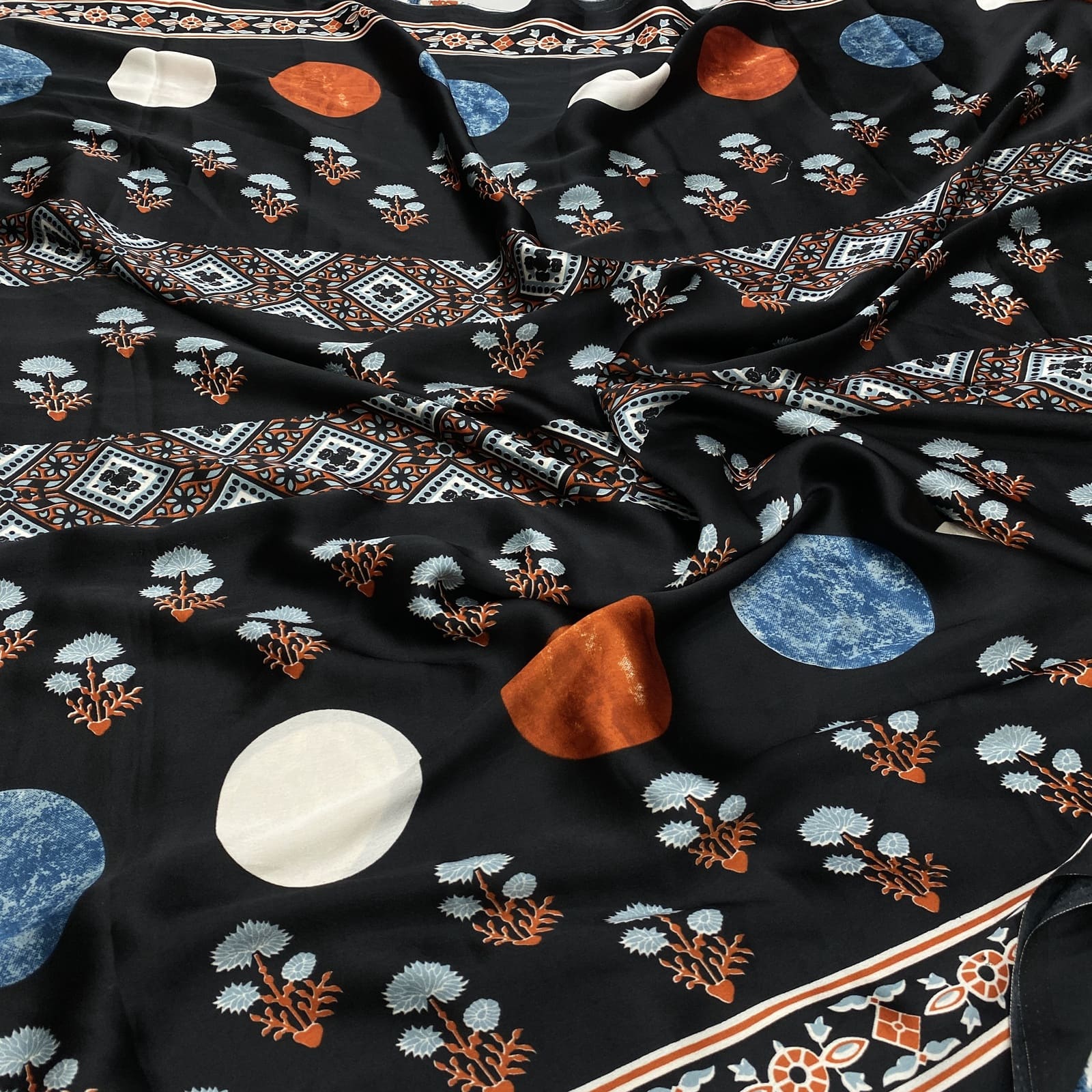 Black satin finish printed saree with rich border design and elegant all-over print