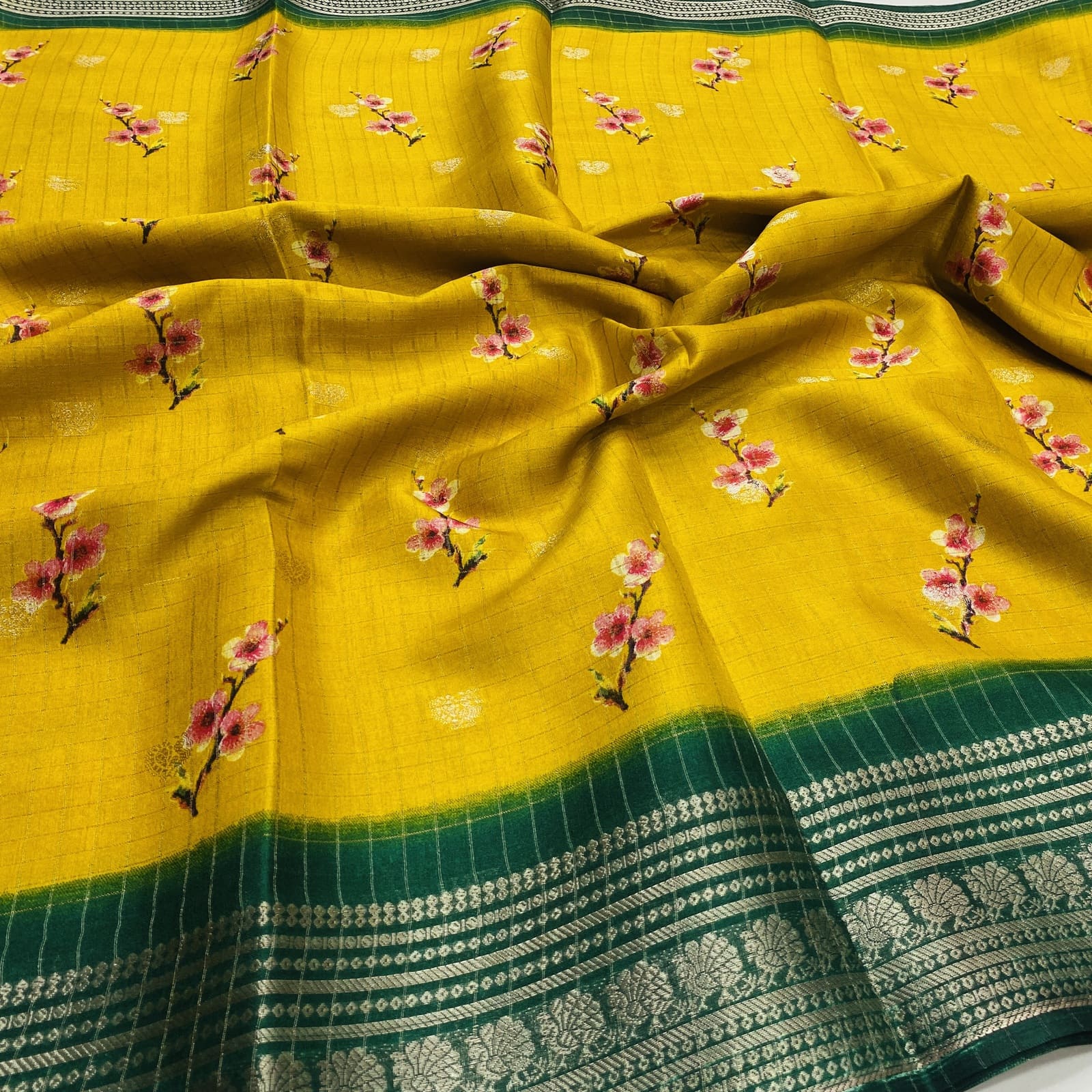 Semi Dola Silk yellow saree with floral butta print and bottle green zari contrast border