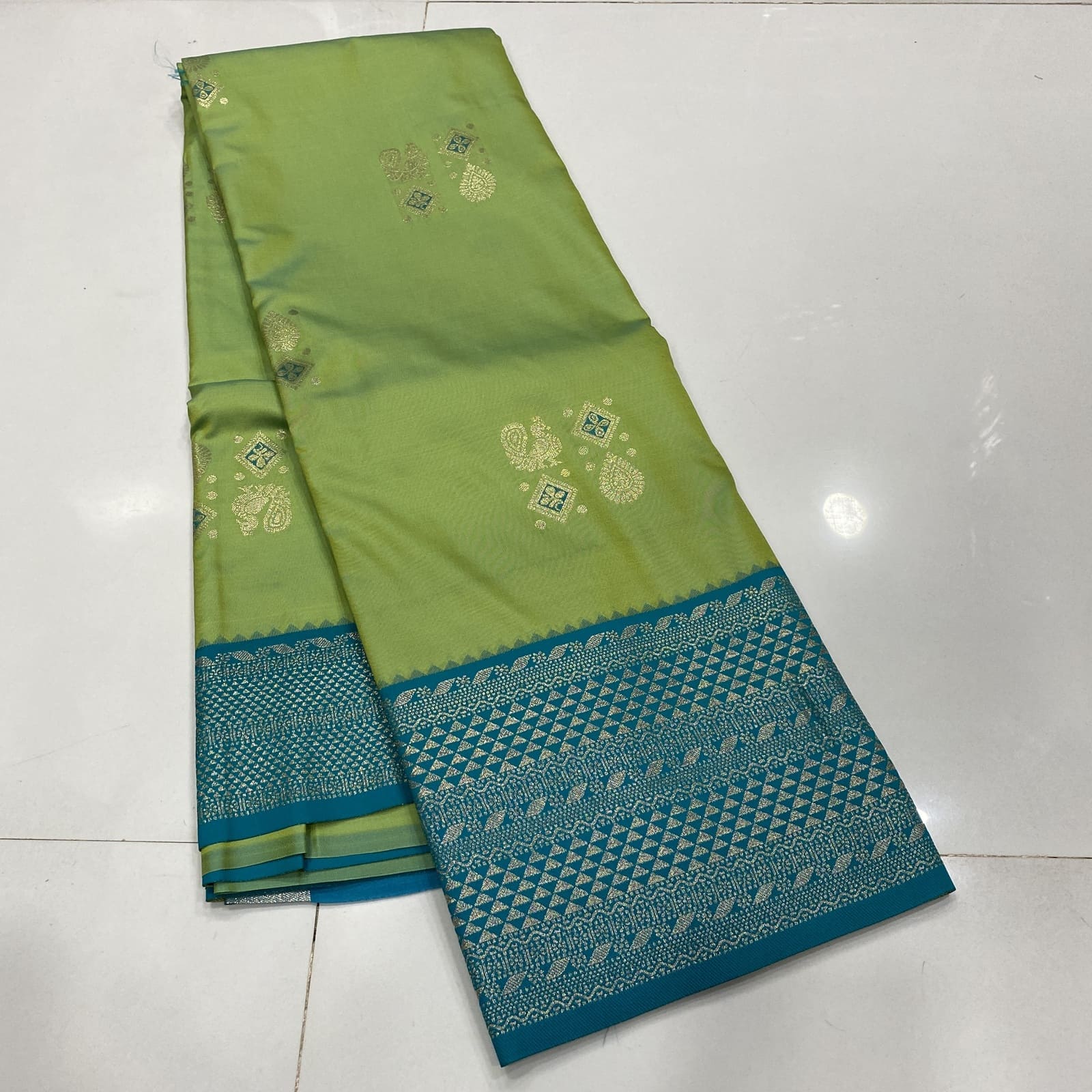 Semi Silk Saree in Green with Teal featuring Annam Rangoli Deepam Butta Design