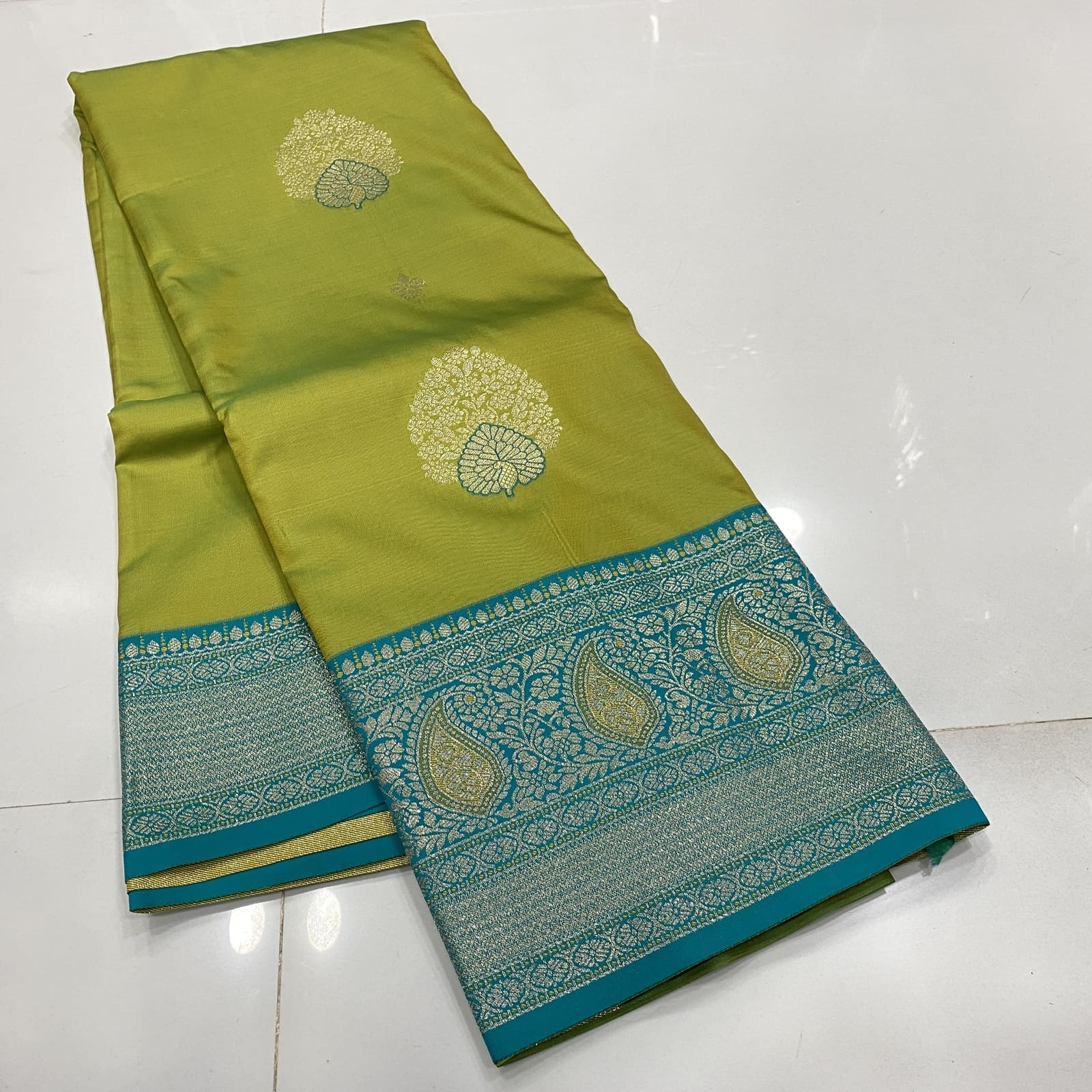 Semi Silk Saree in Green with Blue Border featuring Butta Design
