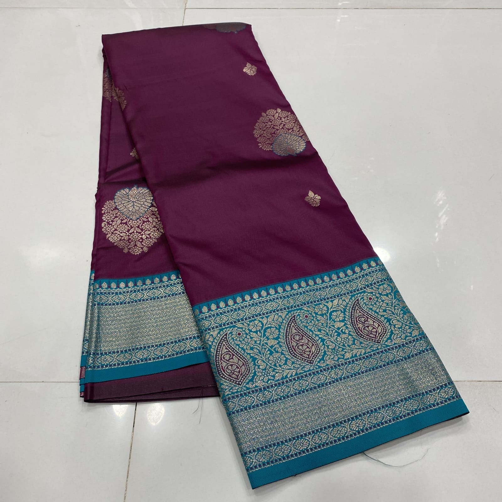 Semi Silk Saree in Wine with Rama Blue Border Folded featuring Butta Design