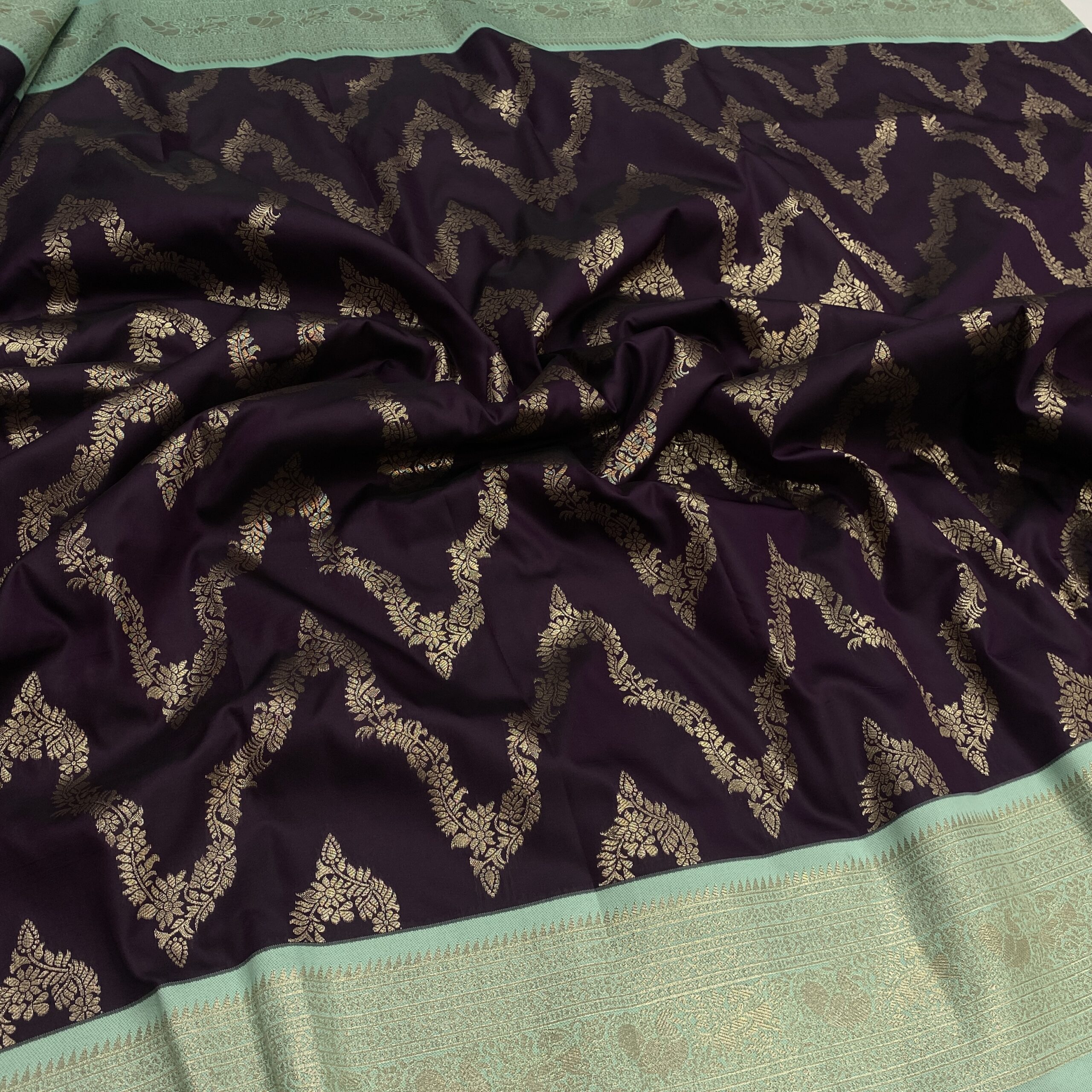 Wine semi Kanchipuram silk saree with waves zari design and pista contrast border