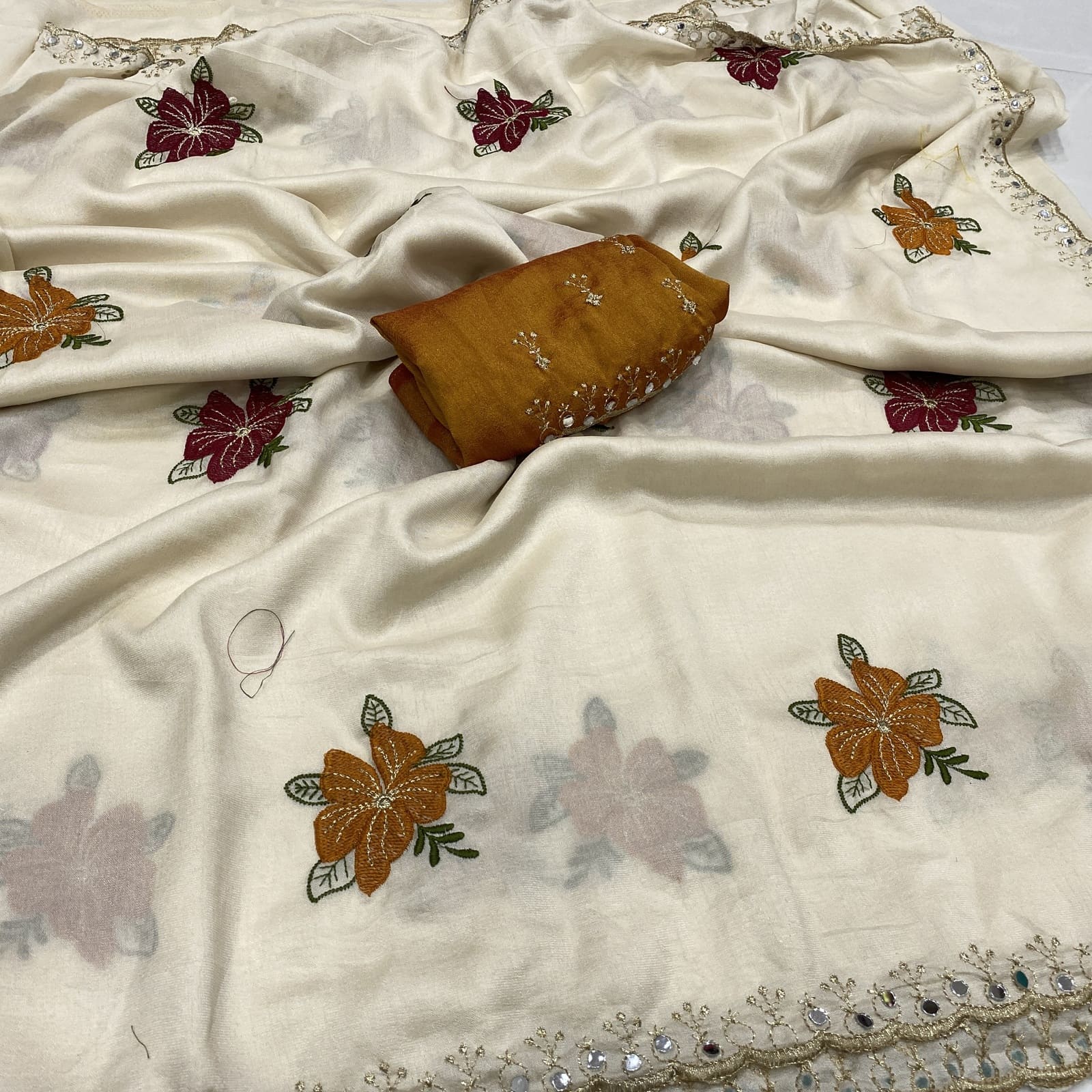 Beige tussar chiffon saree with floral embroidery and faux mirror cut work border