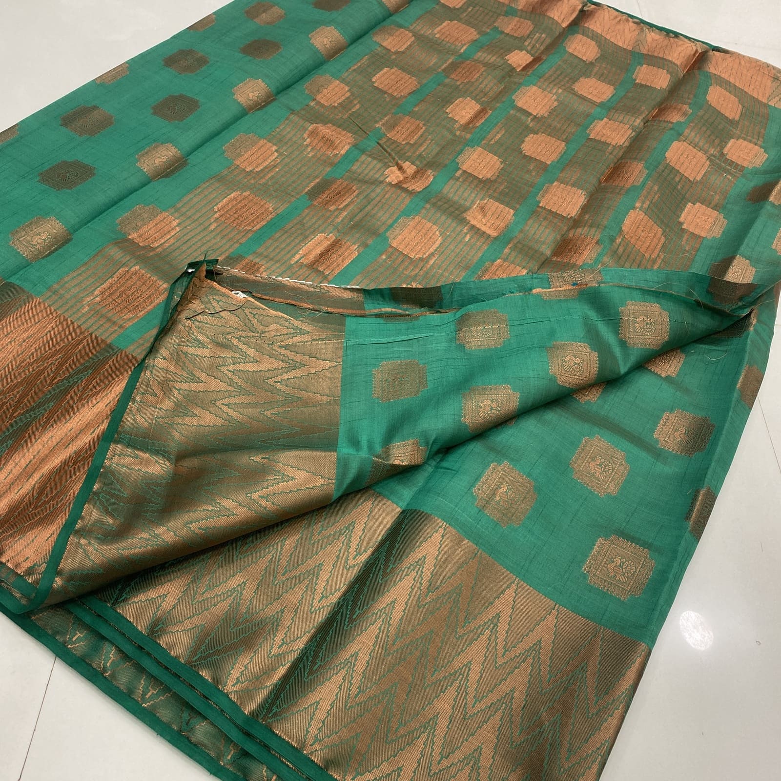 Rama green tussar silk saree chit and peacock copper butta pallu