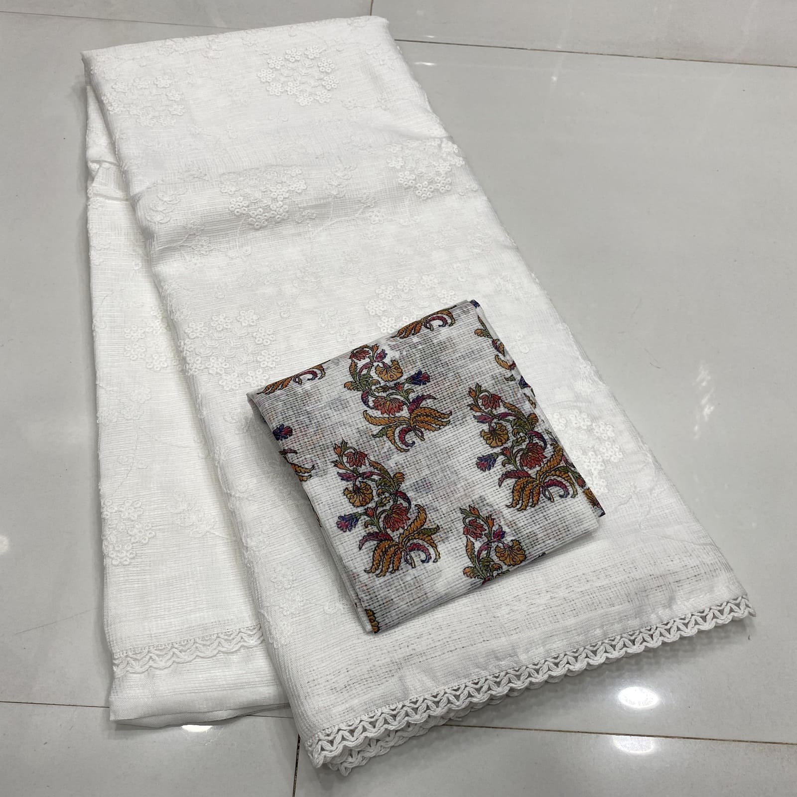 Matching printed blouse for white Kota embroidered saree folded