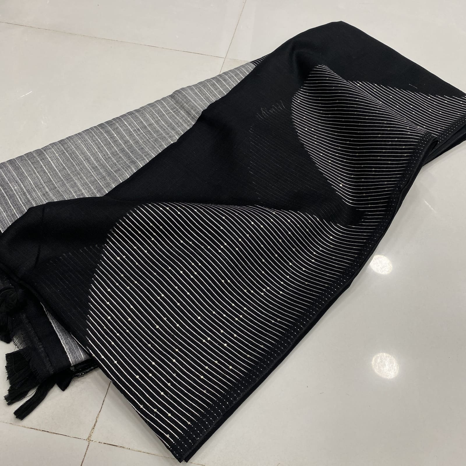 Black linen folded saree with geometric arc sequins border and striped pallu