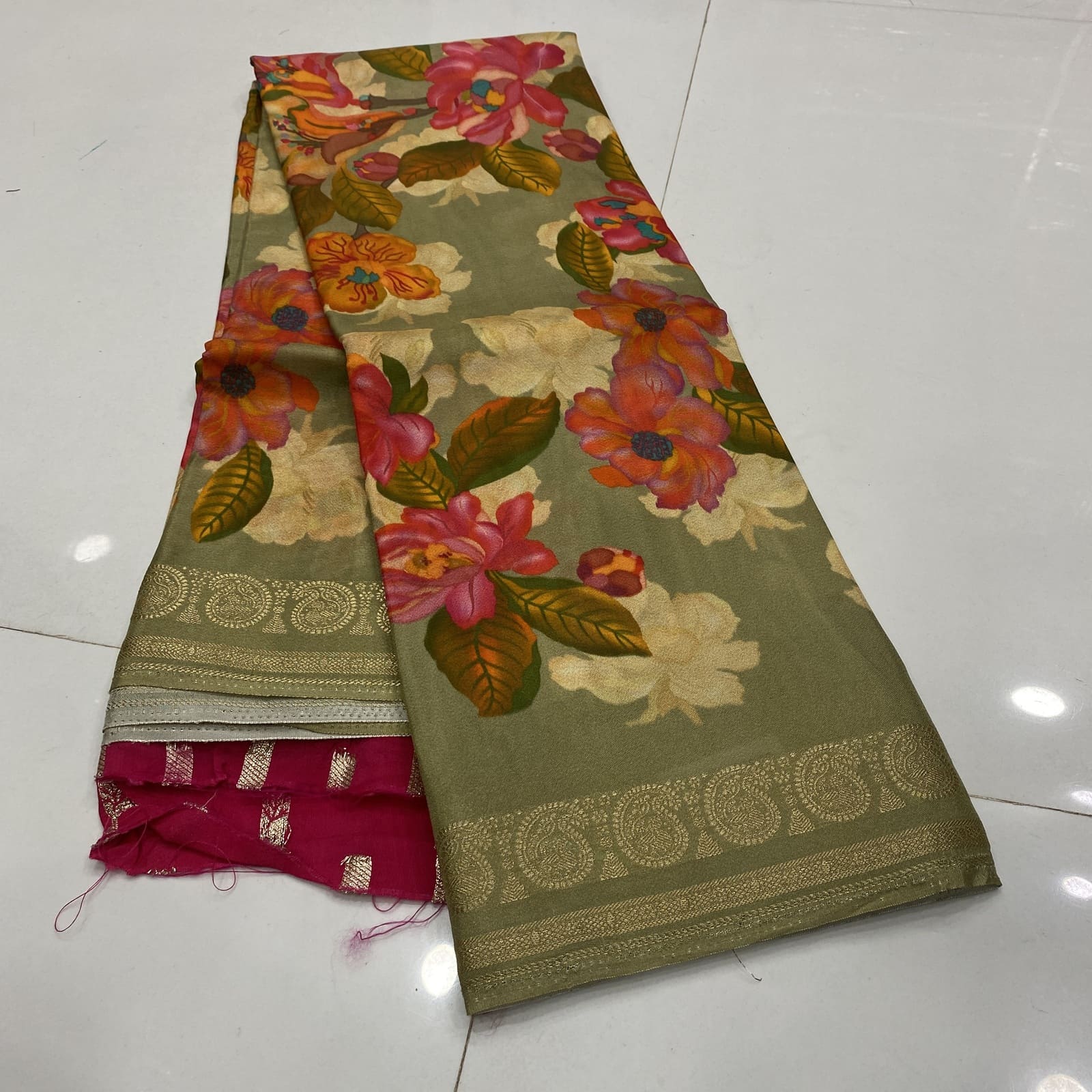 Sage green khalari soft silk saree with floral design and mango zari border folded pic
