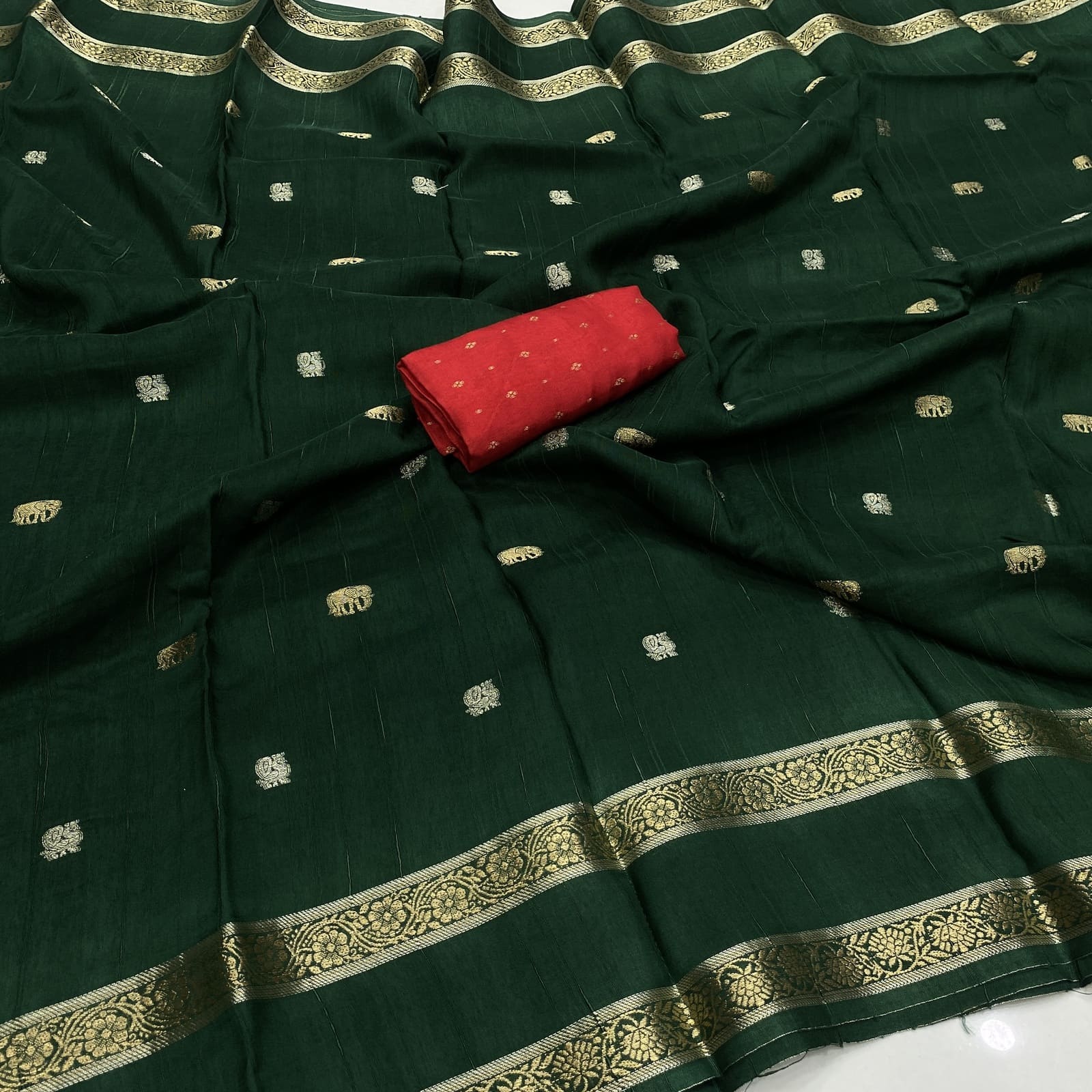Bottle green viscose georgette silk saree with elephant annam butta motifs